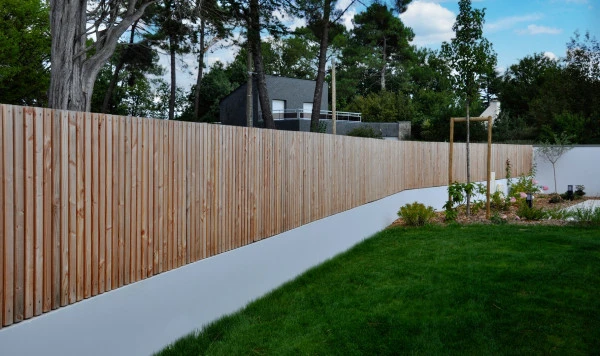 Clôture en liteaux bois sur muret enduit